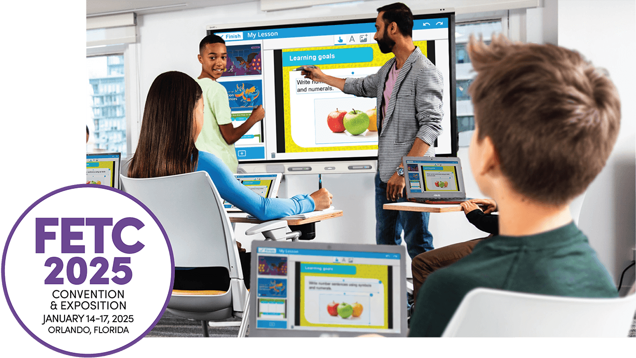Teacher interacting with students using a SMART Board for a Lumio lesson. Students are engaged, working on laptops that display the same lesson. FETC 2025 event logo is visible in the bottom corner.